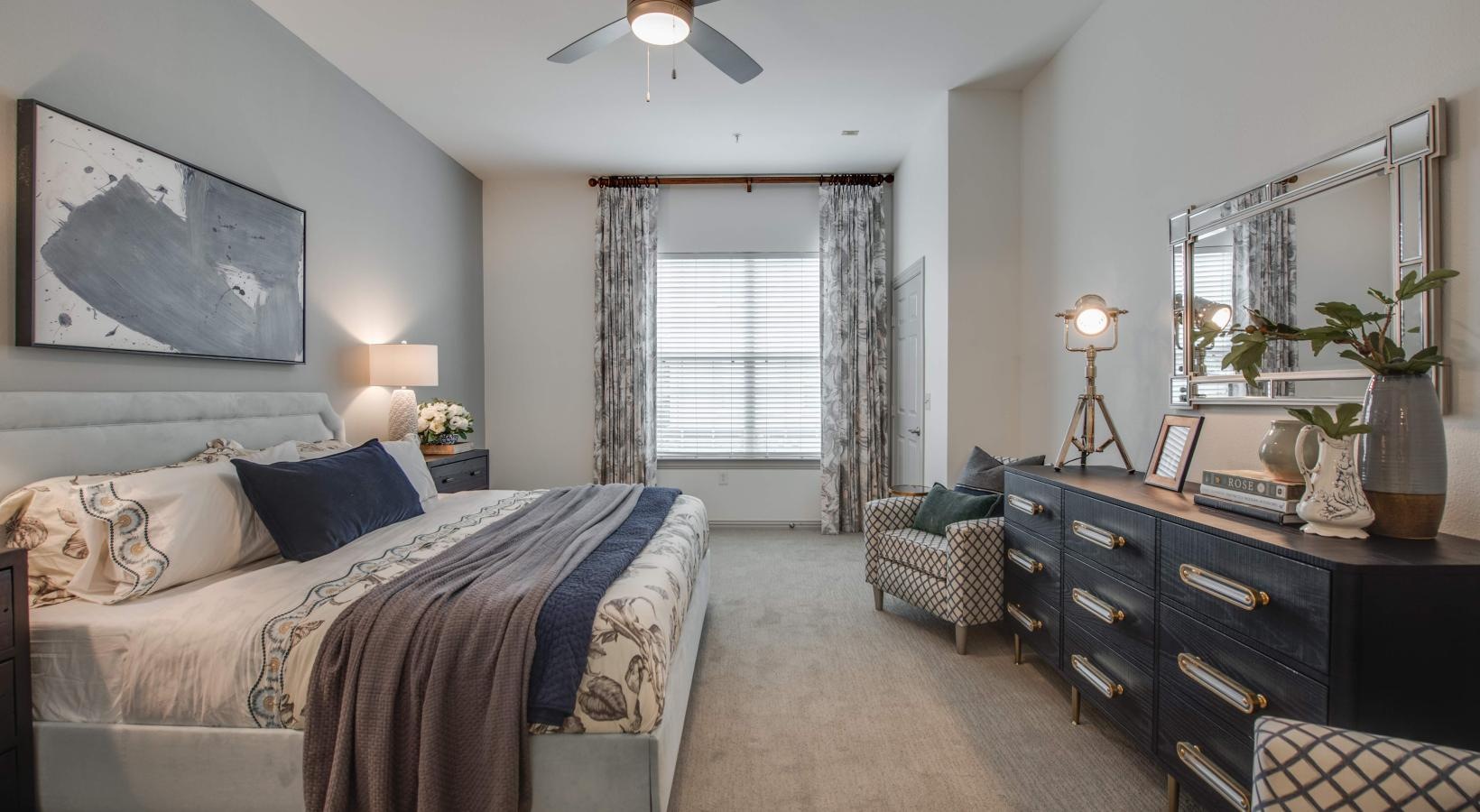 Relax and recharge in beautiful and spacious bedrooms a bedroom with a bed and a fan