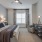 a bedroom with a bed and a fan