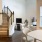 Spacious furnshed living area with large windows and a staircase inside apartment home at Alto Highland Park