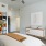 Furnished apartment bedroom with a ceiling fan and carpet inside a home at Alto Highland Park