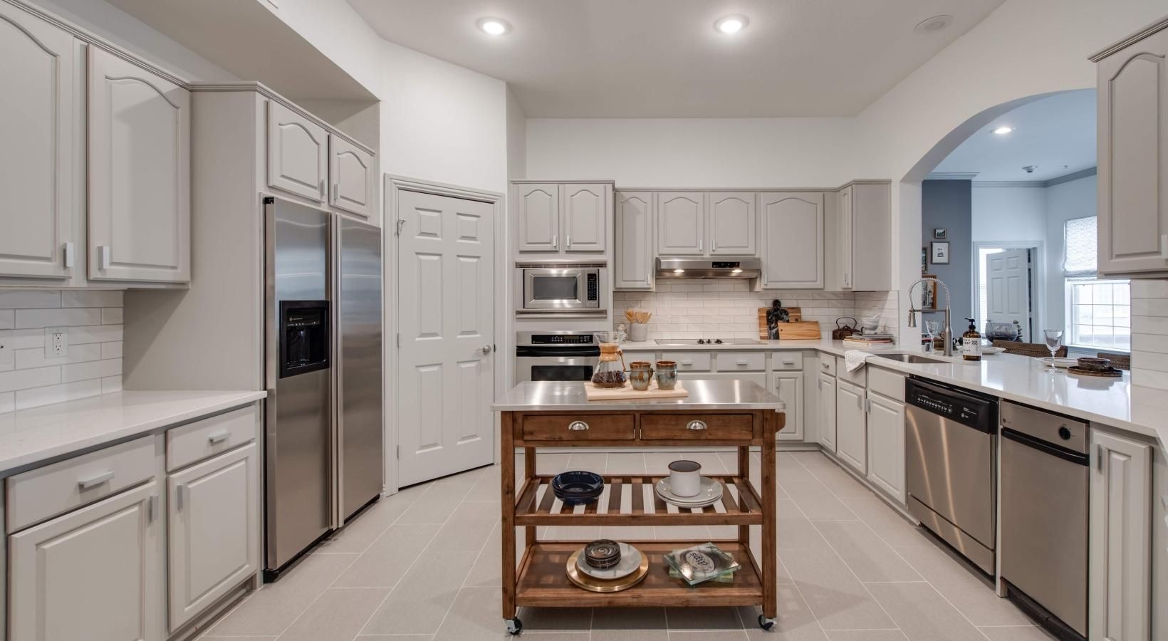 Spacious kitchens with thoughtful details a kitchen with stainless steel appliances