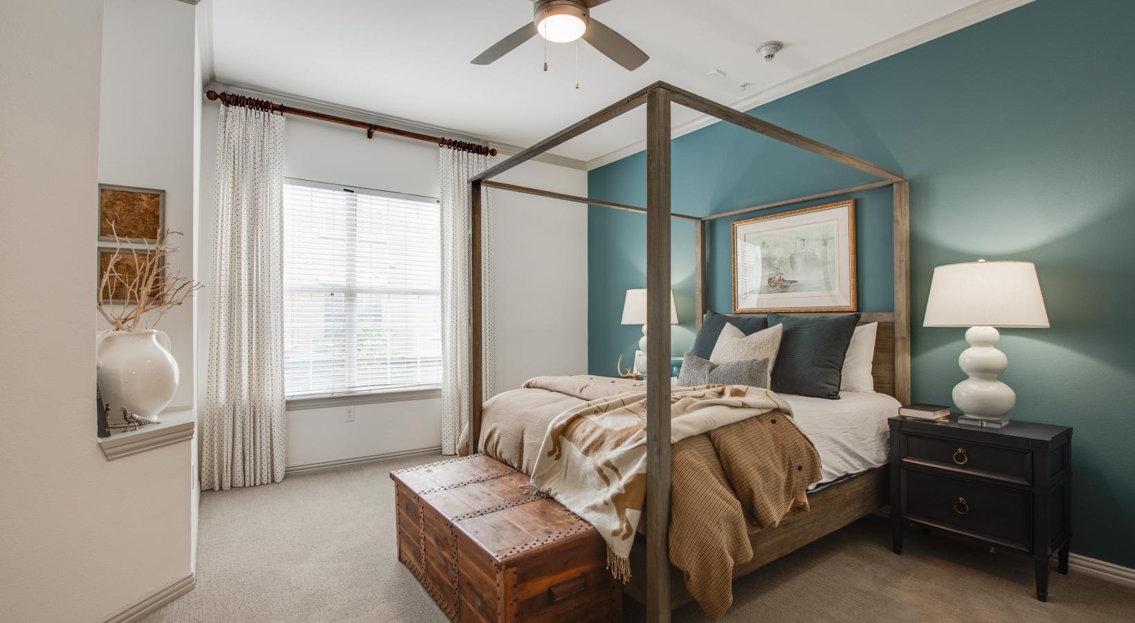 Relax and recharge in beautiful and spacious bedrooms a bedroom with a bed and a fan